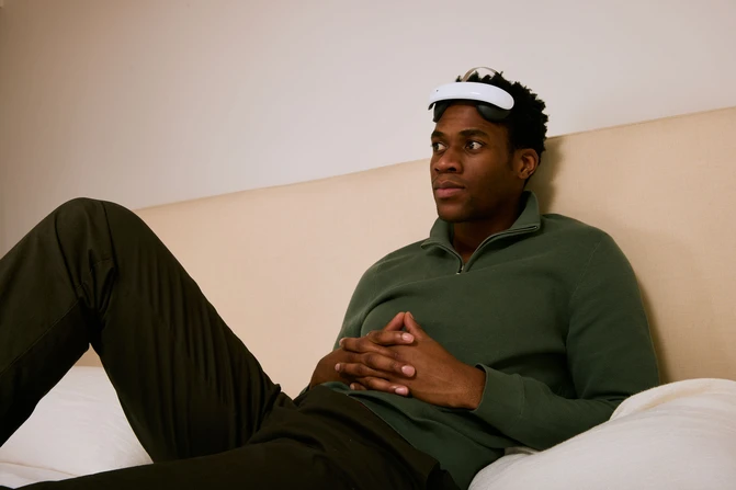 A person relaxing while wearing the Flow headset